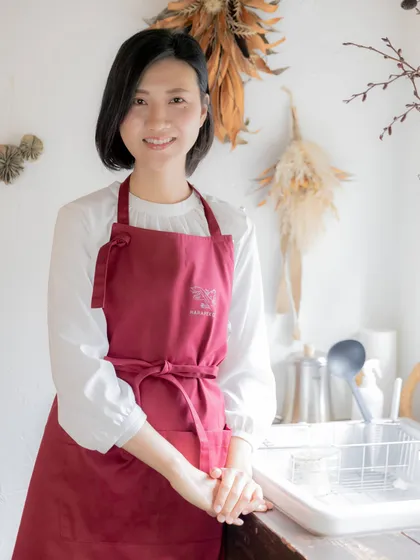 エプロン姿で微笑む栗原なおみ